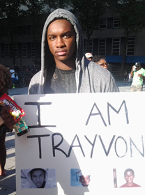 Man holding placard saying 'I am Trayvon'