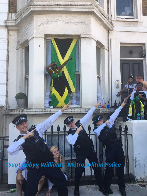 police officers do the Usain Bolt pose at Notting Hill Carnival