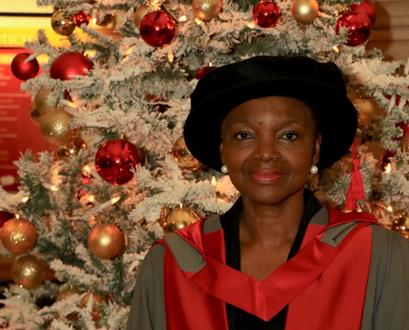 Baroness Amos in front of a Christmas tree