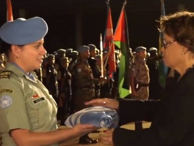 Sandra Honore receives UN flag at ceremony